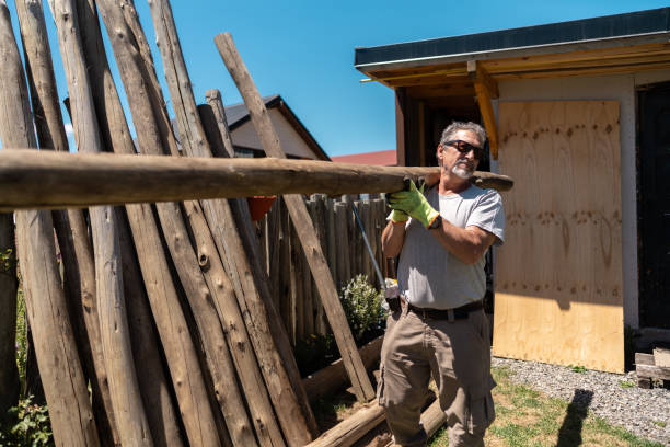 istock Senior man working holding a tree trunk in a house garden 2158322802