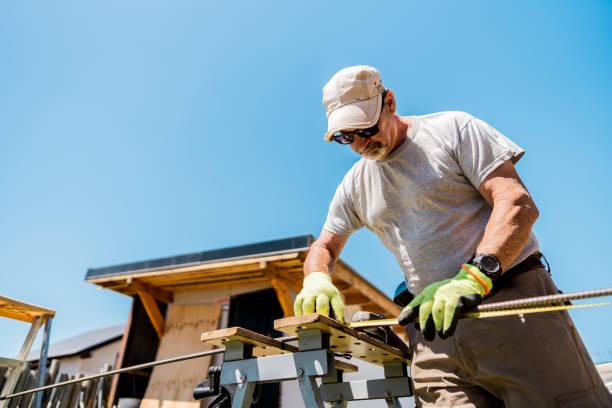 Senior man carpenter working in a house backyard