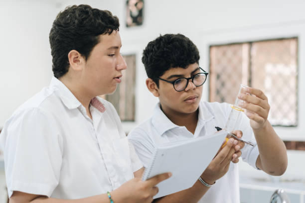 istock Students conducting a scientific experiment in the school laboratory 2158323008