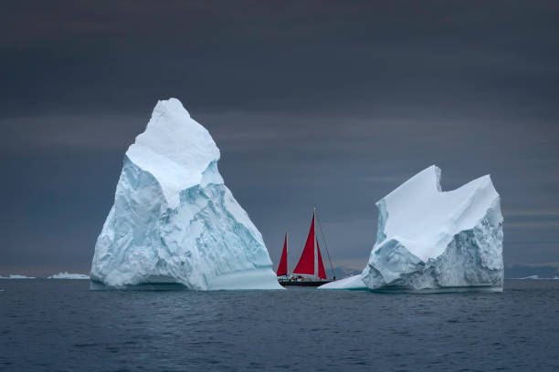 istock two icebergs with one red sailboat 2158323273