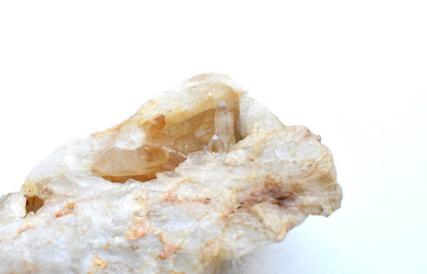 Cluster of natural quartz crystals on a white background.