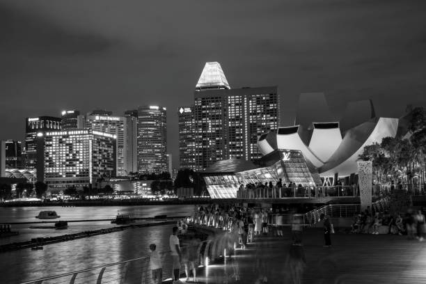 Singapore, Singapore - April 2, 2024. Crowds at Marina Bay Waterfront Promenade at night, Singapore