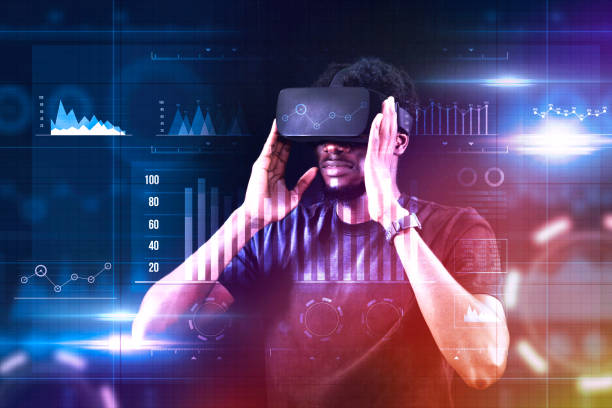 African man, employee wearing VR glasses and working on virtual holographic computer screen. Launching high-technological startup, Young male engineer wearing vr headset.