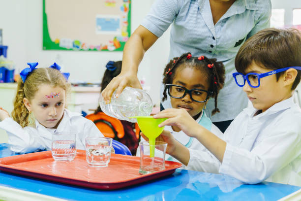 istock Children conducting a scientific experiment in the school laboratory 2158326864