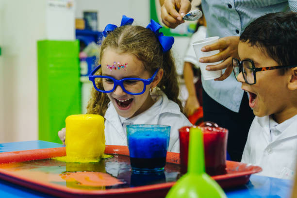 istock Children having fun with scientific experiment in the school laboratory 2158327021