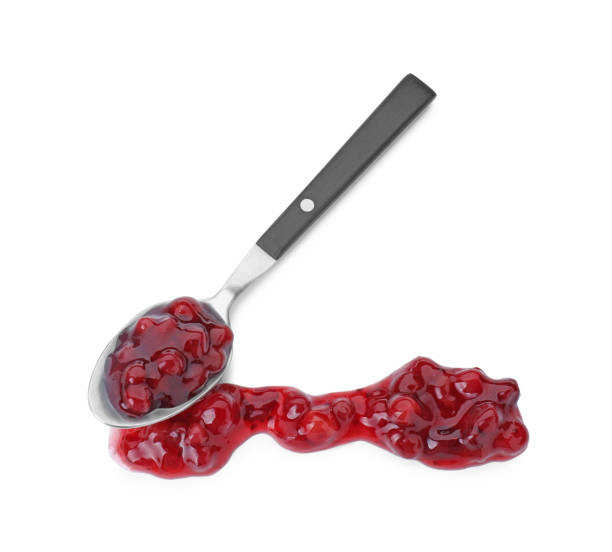 istock Spoon with fresh cranberry sauce isolated on white, top view 2158327573