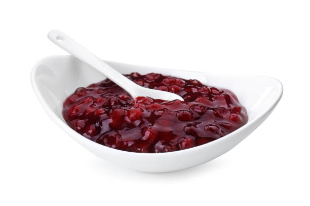 istock Fresh cranberry sauce in bowl isolated on white 2158327579