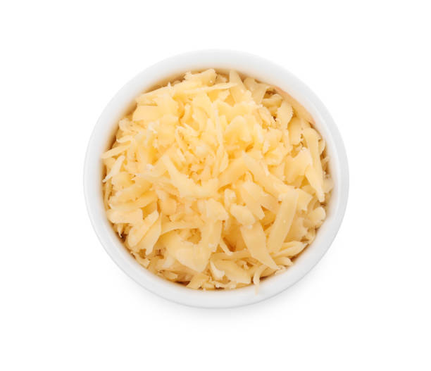 istock Tasty grated cheese in bowl isolated on white, top view 2158327609