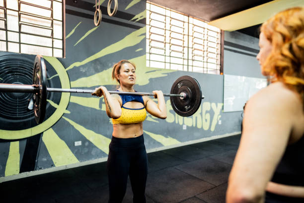 Mature woman doing weightlifting at gym