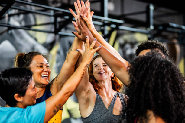 istock Friends celebrating holding hands at the gym 2158327842