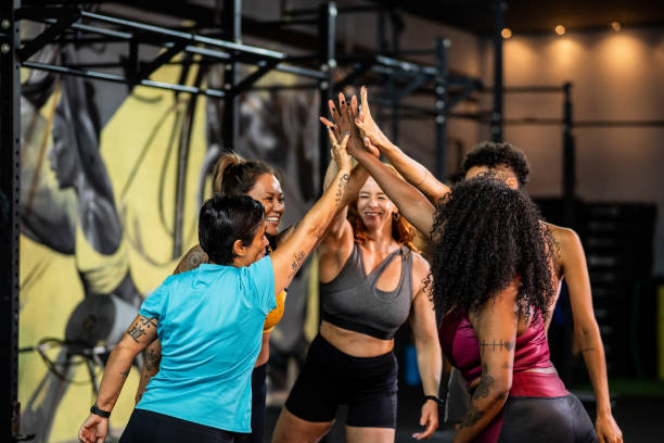 istock Female friends stacking hands in the gym 2158328095
