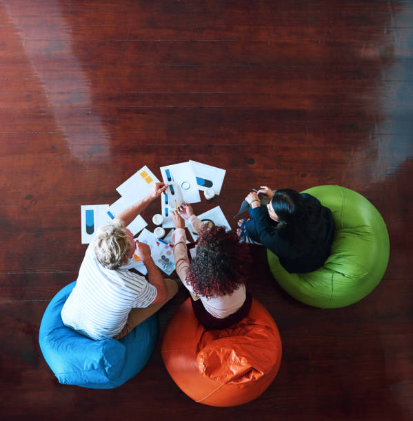 istock Creative people, above meeting and business planning, design teamwork or brainstorming for office website ideas. Group of designers, collaboration and logo documents for branding with paperwork 2158329970