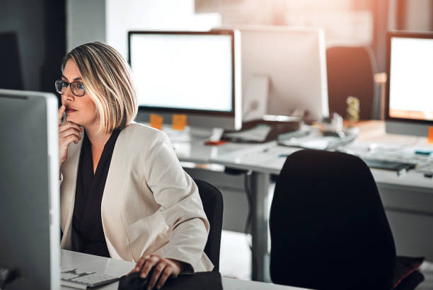 istock Computer, thinking and business woman in office for planning, research or brainstorming. Idea, decision and reading information for problem solving, solution or broker working on email project online 2158331058
