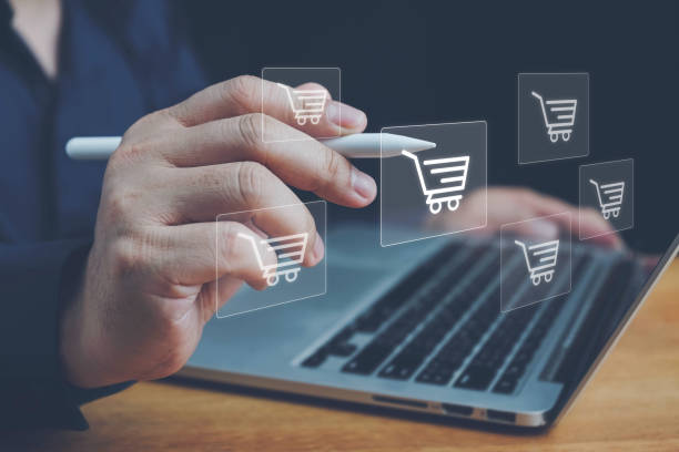 istock Online shopping, order in online store, shopping on internet, concept on virtual screen with hands typing on keyboard, Man using laptop with shopping cart icon. Online shopping and e-commerce concept. 2158331340
