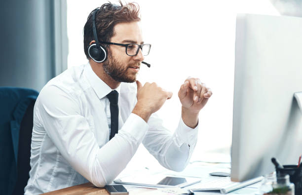 istock Business, man and call centre with headset on computer, help desk and customer service or online advice. Tech support, sales and network with microphone for communication, agent and consultation 2158332733