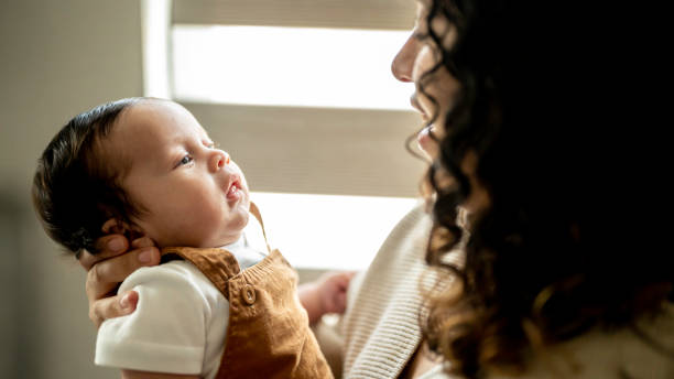 istock Young Hispanic mother cares for her newborn infant son 2158334263