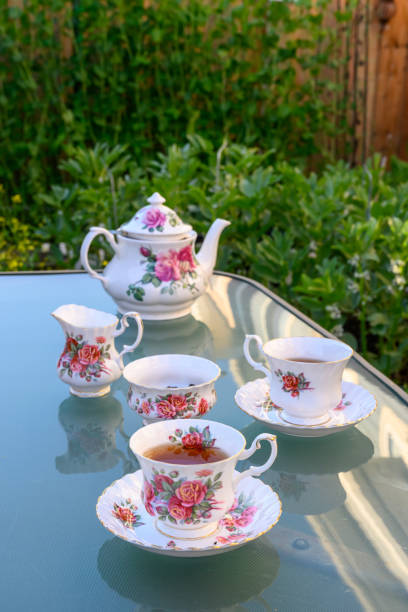 istock Summer time tea table in the garden - rose pattern 1960s vintage fine bone china teacup on garden table 2158335876