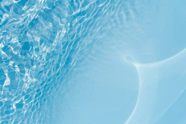 istock Blue water with ripples on the surface. Defocus blurred transparent blue colored clear calm water surface texture with splashes and bubbles. Water waves with shining pattern texture background. 2158340675