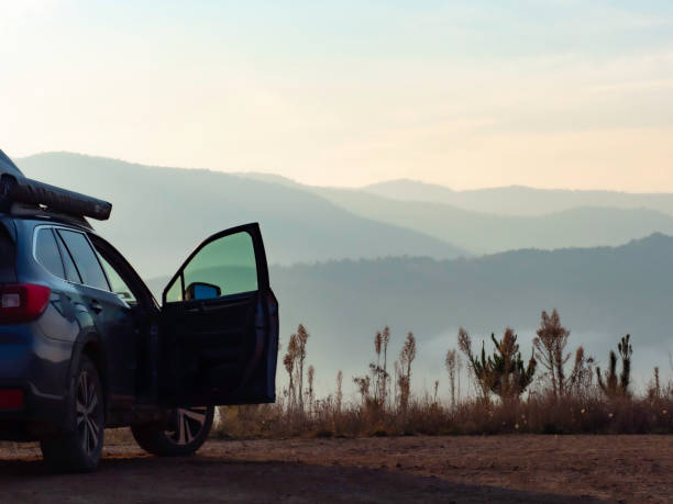 Car with door open looking at early morning mountain views