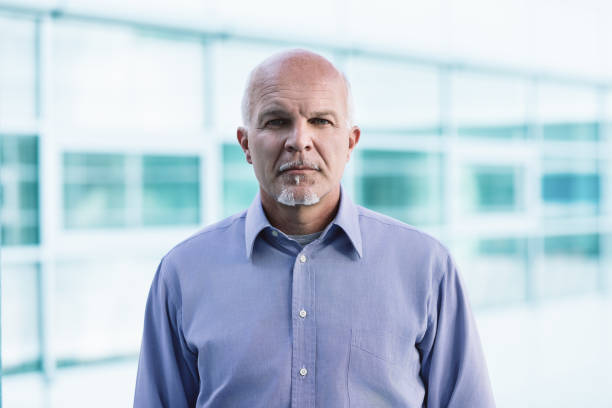 istock Serious businessman standing in modern office building 2158341837