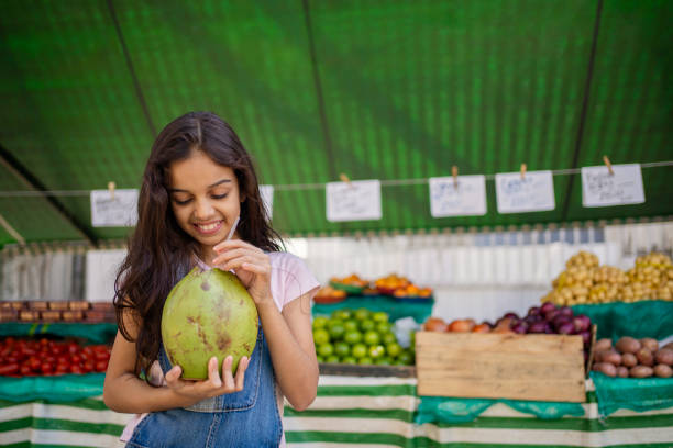 istock Girl drinking coconut water 2158341887