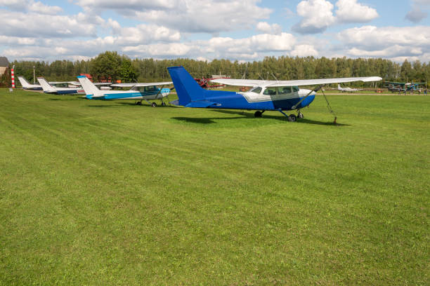 Aerobatic Airplanes Standing On Green Grass In Small Airport