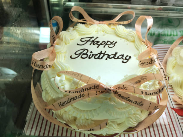 istock Birthday cake decorated with ribbons on display at the bakery. 2158347900