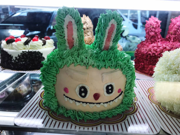 Easter cake with bunny ears on top in bakery shop window.