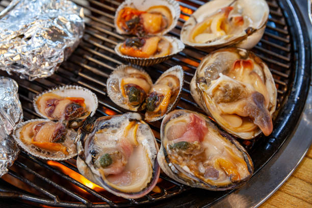 Shellfish are boiling on a fire-fired grill