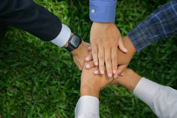 istock world environment day Global teamwork for a sustainable environment Businessmen join forces to help save the world. 2158353822