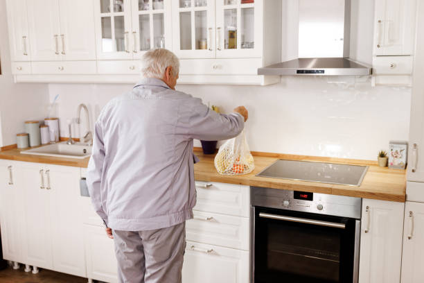 istock Senior man returns home after shopping 2158357098