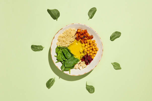 istock Vibrant Bowl with Sweet Potato, Chickpeas, Quinoa, Spinach, and Mango Sauce on Light Background 2158358626