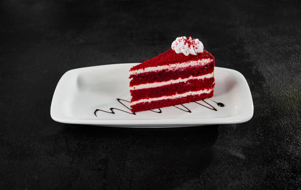 istock Delicious Red Velvet Cake Slice on White Plate Against Dark Background 2158358642