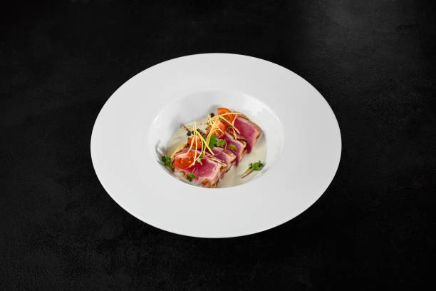 istock Seared Tuna Tataki with Garnish on White Plate in Minimalist Setting 2158358829