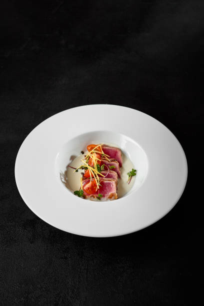 istock Premium Seared Tuna Tataki Dish on Elegant White Plate with Dark Background 2158358863