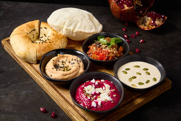 istock Assorted Mezze Platter with Pita and Flatbread, Hummus, Beetroot Hummus, Eggplant Ajapsandali, Tonnato Sauce 2158358881