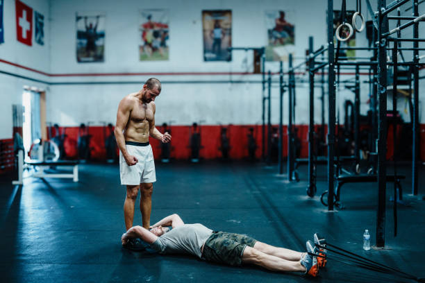 istock Man works with personal trainer in the gym 2158359333