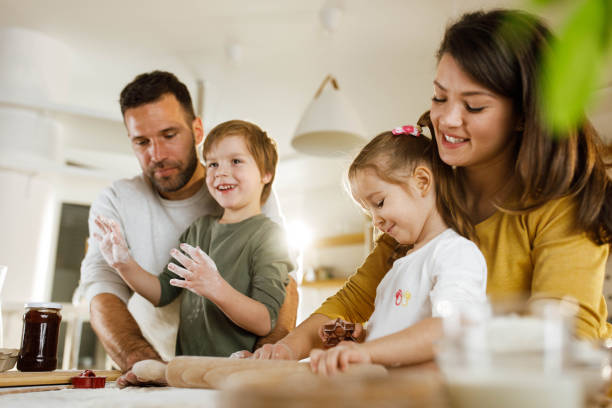 istock Happy family making a cake in the kitchen. 2158362335