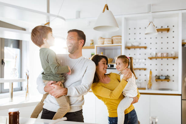 istock Cheerful parents having fun with their kids at home. 2158362426