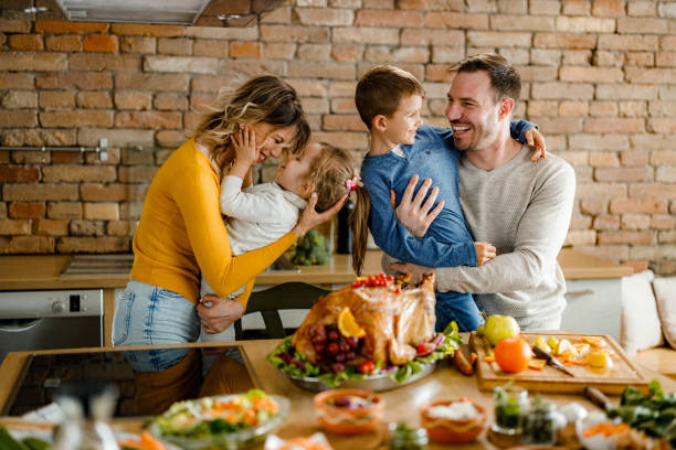 istock Happy family having fun during Thanksgiving day in the kitchen. 2158363020
