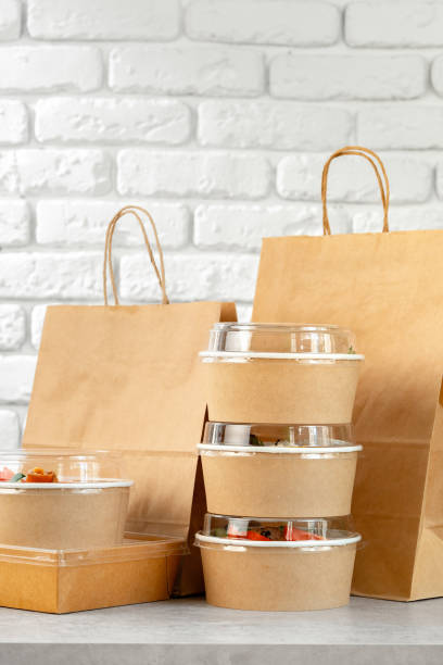 istock Take out food in boxes and craft bag against brick background 2158363605
