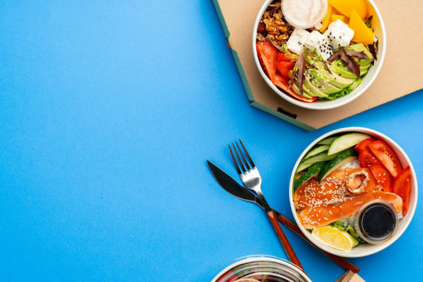 istock Different poke bowls on blue background top view 2158364276