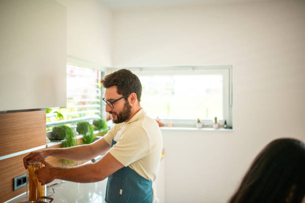 istock Hispanic Chef Prepares Gourmet Dish in Bright Kitchen 2158364709