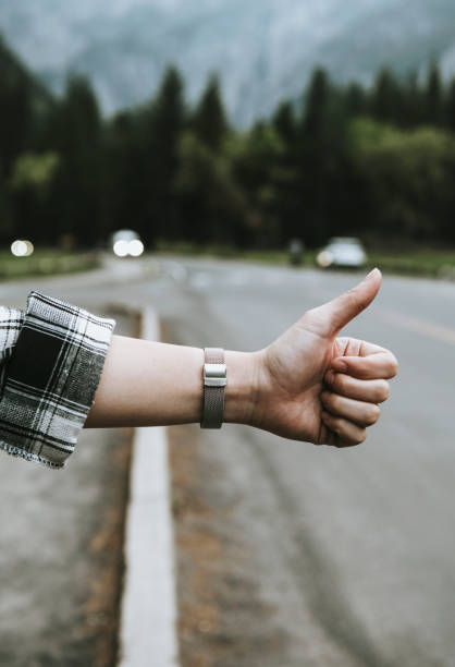 istock Man hitchhiking by the roadside 2158364727