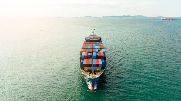 istock cargo container ship sailing in sea to import export goods and distributing products to dealer and consumers worldwide, by container ship Transport, business delivery service, aerial  view 2158364764