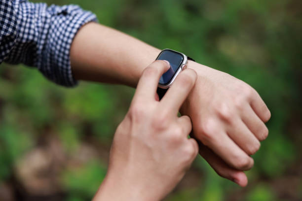 istock Close up, man using smart watch, setting up his smart watch in the forest, goal achievement, sport and fitness concept outdoors in nature. 2158364766