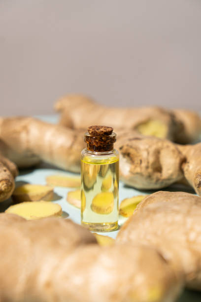 istock Natural ginger oil in glass bottle among ginger roots 2158367032