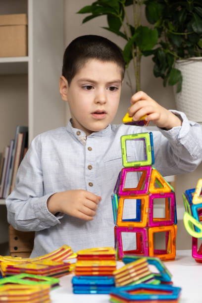 istock A six-year-old boy plays with a magnetic construction set. Toys for children to develop imagination. 2158367062
