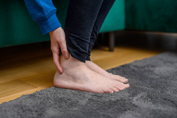 istock Women's bare feet close up, ankle pain 2158369387