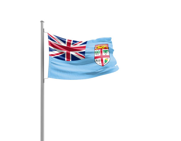 The image shows the national flag of Montserrat, featuring the Blue Ensign with the Union Jack in the upper left corner and the territory’s coat of arms on the right. The emblem shows a woman in a green dress holding a harp and a black cross, symbolizing Irish heritage and cultural identity.